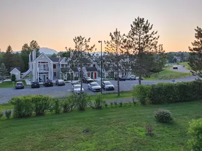 a street with cars parked in a parking lot at Chalet Tranquillité Orford in Magog-Orford