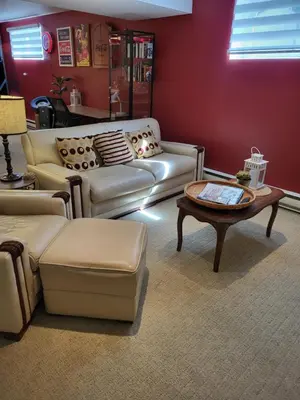 a living room with two couches and a coffee table at Chez Carole - Établissement d'hébergement de résidence principale sur la Rive-Sud de Montréal in Mercier