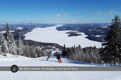 a group of people skiing down a snow covered slope at Chalet a Samia - Spa, luxury, Jay Peak view in Mansonville