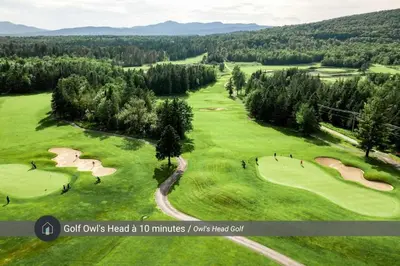 an overhead view of a golf course with people playingolf at Chalet a Samia - Spa, luxury, Jay Peak view in Mansonville