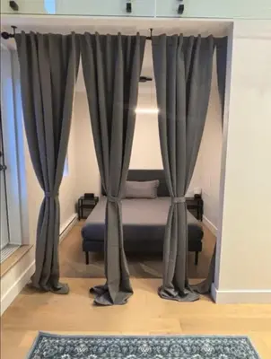 a bedroom with a bed with curtains and a rug at Luxury apartment in Mont Royal in Montréal