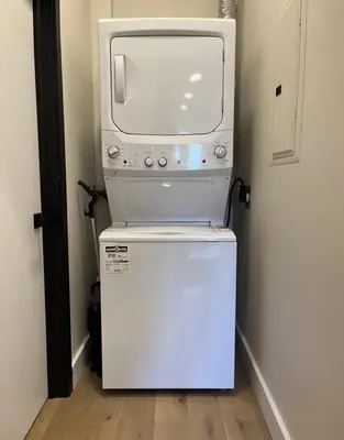 a microwave sitting on top of a small refrigerator at Luxury apartment in Mont Royal in Montréal