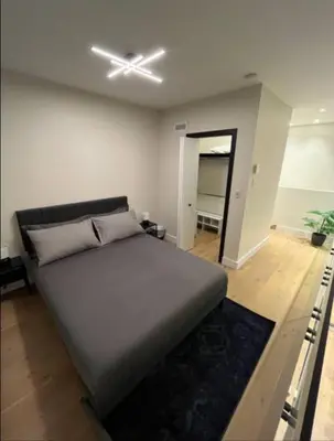 a bedroom with a bed and a ceiling fan at Luxury apartment in Mont Royal in Montréal