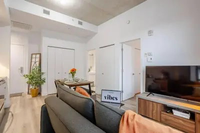 a living room with a couch and a flat screen tv at Elegant 1BR Retreat and Chic Stay in Old Port in Montréal