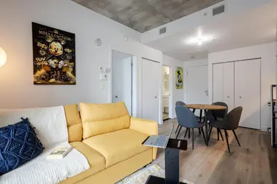 a living room with a couch and a table at Sophisticated 1BR Escape , Charm in Old Port in Montréal