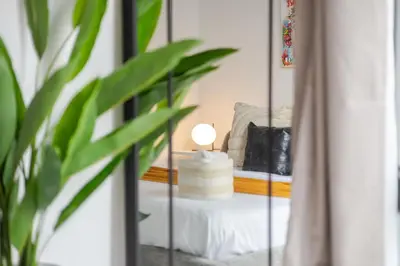 a mirror in a room with a bed and a lamp at Sophisticated 1BR Escape , Charm in Old Port in Montréal