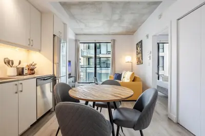 a kitchen and dining room with a table and chairs at Sophisticated 1BR Escape , Charm in Old Port in Montréal