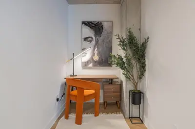 a desk with a chair and a painting on the wall at Exclusive Sanctuary Elegance Meets Comfort in Montréal