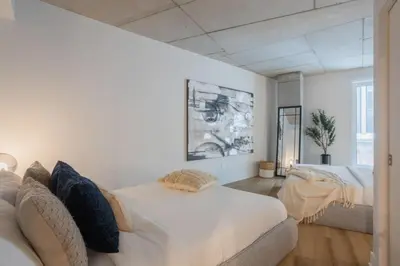 a living room with two beds and a couch at Exclusive Sanctuary Elegance Meets Comfort in Montréal