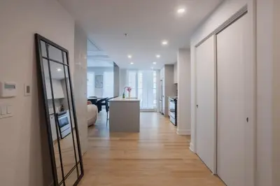 a hallway with a mirror and a living room at Exclusive Sanctuary Elegance Meets Comfort in Montréal