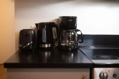 two coffee pots sitting on top of a kitchen counter at Sleek 2BR in Heart of Downtown Montreal in Montréal