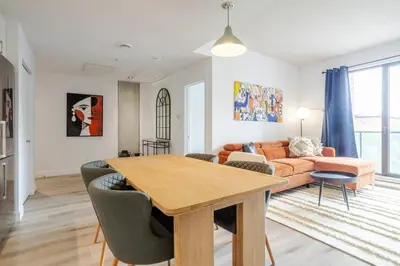a living room with a table and a couch at Modern Heritage Stay Upscale 2BR in Old Port in Montréal