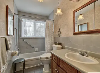 a bathroom with a sink and a toilet and a tub at 2 beds in a private room B with a free parking -15 min from downtown in Longueuil
