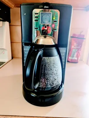 a coffee maker with a phone on top of it at 2 beds in a private room B with a free parking -15 min from downtown in Longueuil