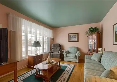 a living room with a couch and a table at 2 beds in a private room B with a free parking -15 min from downtown in Longueuil
