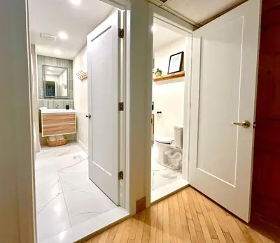 a bathroom with a door leading to a toilet at MTLVacationRentals - The City Chalet in Montréal