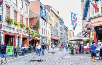 a group of people walking down a city street at MTLVacationRentals - The City Chalet in Montréal