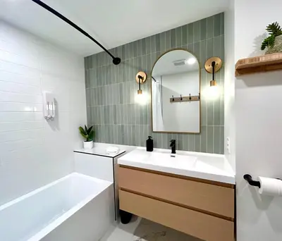a bathroom with a sink and a tub and a mirror at MTLVacationRentals - The City Chalet in Montréal