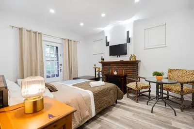 a bedroom with a bed and a desk and a table at Confort Suprême Grand Appartement 3 Chambres Design in Montréal