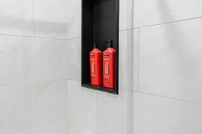 two red fire hydrants in a black holder on a wall at Confort Suprême Grand Appartement 3 Chambres Design in Montréal