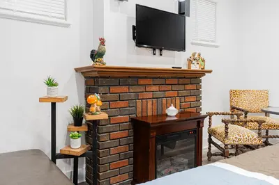 a living room with a fireplace with a flat screen tv at Confort Suprême Grand Appartement 3 Chambres Design in Montréal