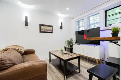 a living room with a couch and a table at Confort Suprême Grand Appartement 3 Chambres Design in Montréal