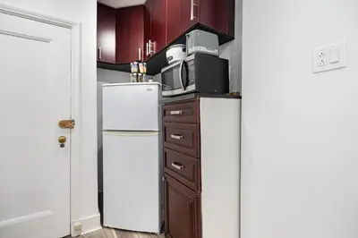 a kitchen with a refrigerator and a microwave at Confort Suprême Grand Appartement 3 Chambres Design in Montréal