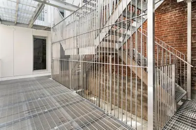 a metal staircase in a room with a brick wall at Habitat in Montréal
