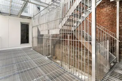 a metal cage with a staircase in a building at Habitat in Montréal