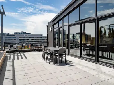 a patio with a table and chairs on a building at Cozy apartment-Old Port Montreal in Montréal