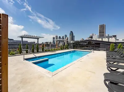 a swimming pool on top of a building with a skyline at Cozy apartment-Old Port Montreal in Montréal