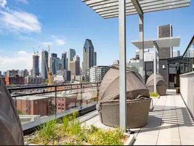 a rooftop balcony with a view of a city at Cozy apartment-Old Port Montreal in Montréal