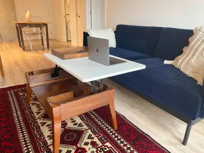 a living room with a couch and a laptop on a table at Cozy apartment-Old Port Montreal in Montréal