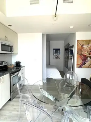 a dining room with a glass table and chairs at Loft moderne au coeur de Montreal in Montréal