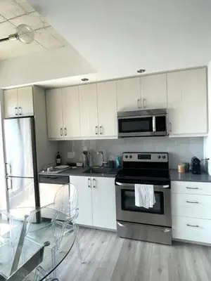 a kitchen with a stainless steel stove and a microwave at Loft moderne au coeur de Montreal in Montréal