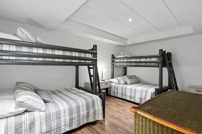 two bunk beds in a room with wooden floors at Impérial du Domaine de la Chasse Gardée in Linière