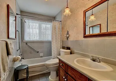 a bathroom with a sink and a toilet and a tub at Private roomC Fee parking 15min downtown in Longueuil