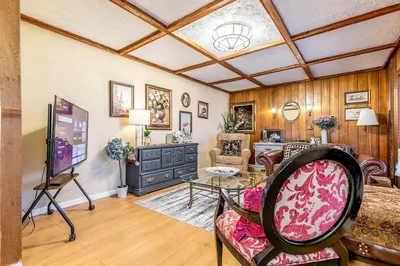 a living room with a couch and a table at Stylish 6-BR House close to DT with free parking in Brossard