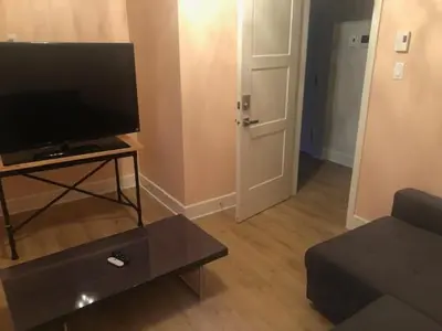 a living room with a flat screen tv and a couch at All inclusive pied à terre near airport 2nd bed extra twenty dollars cash in Pointe-Claire