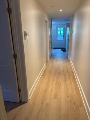 a hallway of a home with a hard wood floor at All inclusive pied à terre near airport 2nd bed extra twenty dollars cash in Pointe-Claire