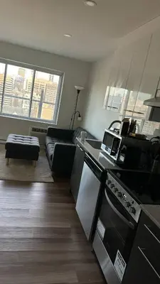 a kitchen and living room with a stove and a couch at Great view 1BDRM APTR in heart of Montreal DWTN in Montréal