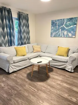 a living room with a couch and a coffee table at 2 bedroom, subway, free parking. in Longueuil