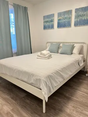 a bed in a bedroom with two towels on it at 2 bedroom, subway, free parking. in Longueuil