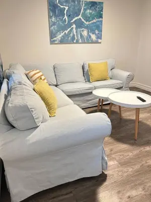 a living room with a couch and two tables at 2 bedroom, subway, free parking. in Longueuil