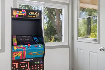 a video game machine sitting next to a door at Escapade Chambly in Chambly