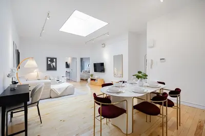 a living room with a table and chairs and a couch at La Galerie Privée Luxe & Impeccable Stay in Montréal