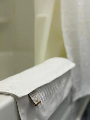 a piece of paper sitting on top of a toilet at La Galerie Privée Luxe & Impeccable Stay in Montréal