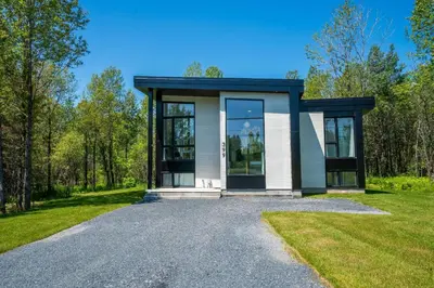 a small house on a gravel driveway at Spa & Adventure - Chalet Valikas in Weedon-Centre