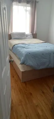 a bed in a bedroom with a window at Résidence le HAvre in Laval