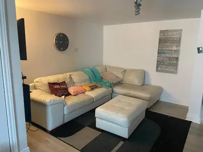 a living room with a couch and a table at Résidence le HAvre in Laval